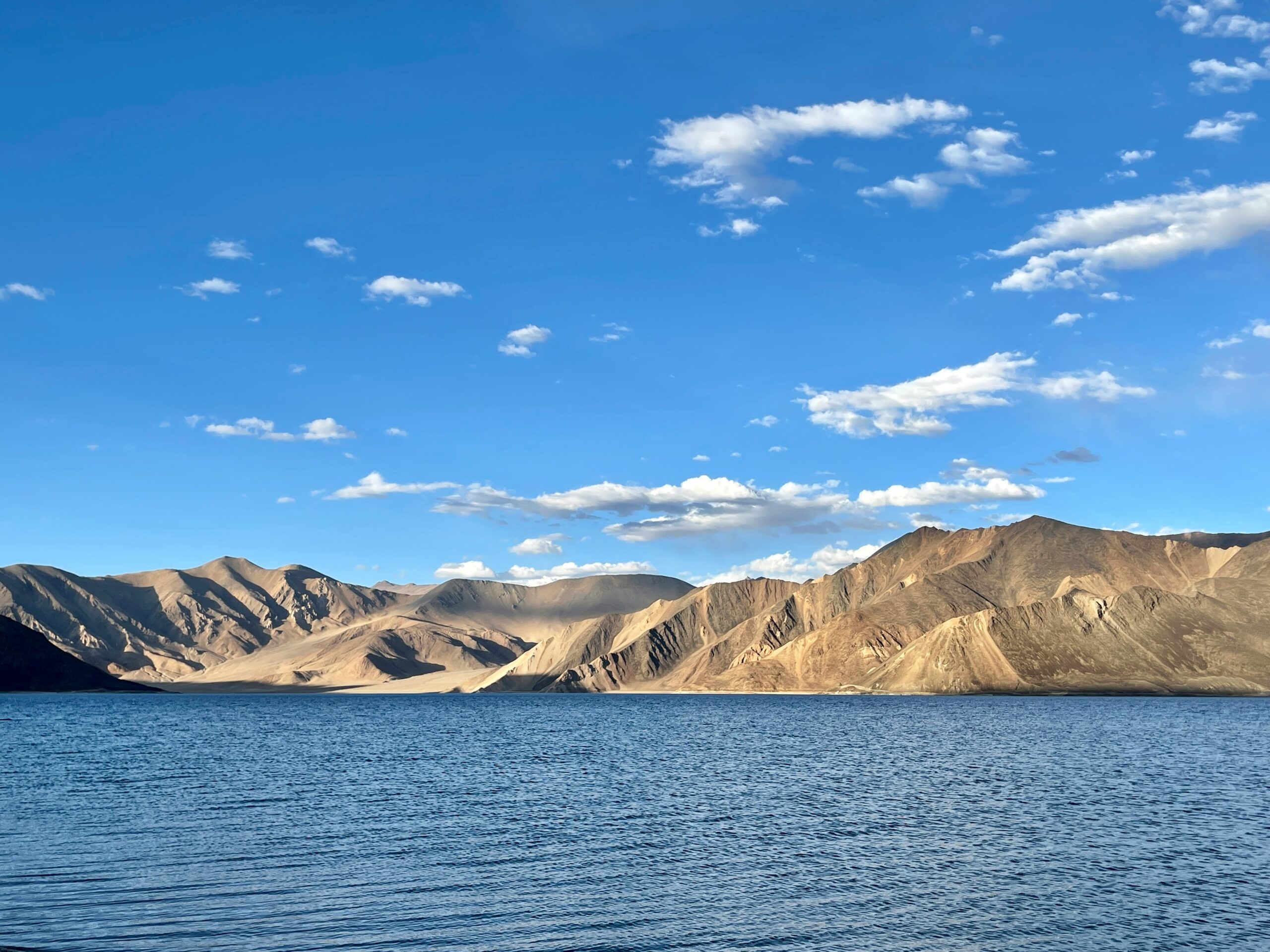 Panoramic view of Pangong Tso lake with mountains in the background - India travel guide